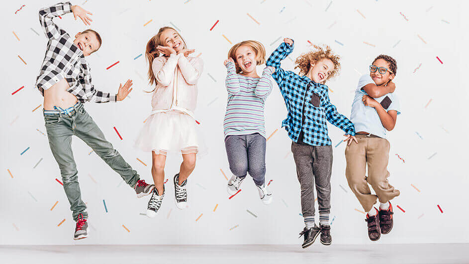 Fünf Kinder springen fröhlich in die Luft